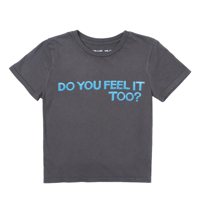Front view of Billie Eilish’s cropped baby tee in washed black, with bold blue bubble-style lettering that reads “DO YOU FEEL IT TOO?” across the chest. A soft and snug-fit crop top from the official HIT ME HARD AND SOFT merch line.