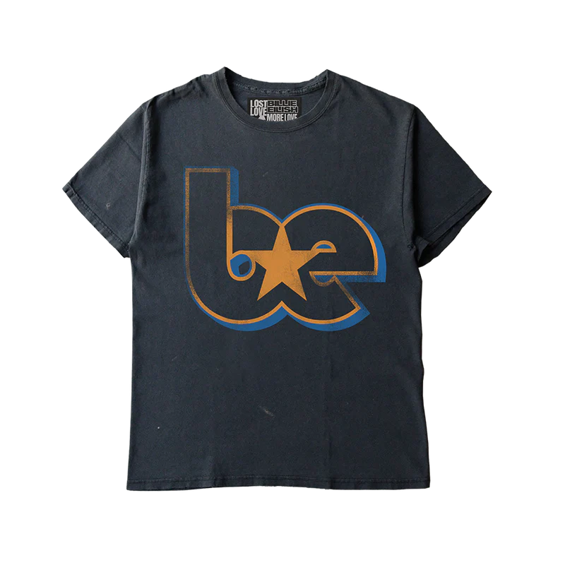 Black Billie Eilish x Lost Love tee featuring a bold “be” graphic with a gold star at the center, printed in a retro-inspired font. Made from reworked materials, this upcycled streetwear tee blends sustainability and iconic style.