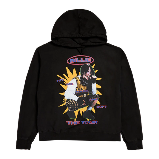 Front view of Billie Eilish's HIT ME HARD AND SOFT WORLD TOUR pullover hoodie in black, featuring a vibrant collage of Billie crouching with comic-style text and a yellow burst background. This bold and colorful hoodie is part of the official 2024 world tour merch drop.

