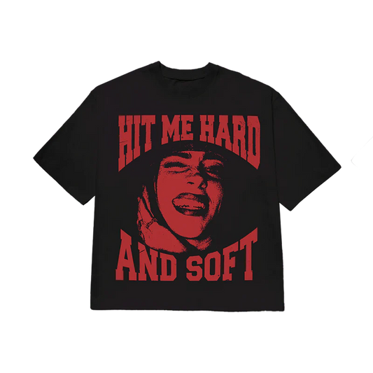 Black Billie Eilish T-shirt with a striking red graphic of her face and bold “Hit Me Hard and Soft” lettering, inspired by her 2024 album. Official Billie Eilish merch combining bold visuals with iconic music branding.

