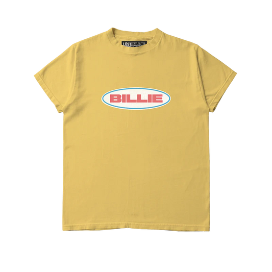 Mustard yellow Billie Eilish x Lost Love T-shirt featuring a bold retro-style "BILLIE" logo in red text inside a white oval with teal outline. Eye-catching sustainable merch tee made from reworked materials with a vintage vibe.

