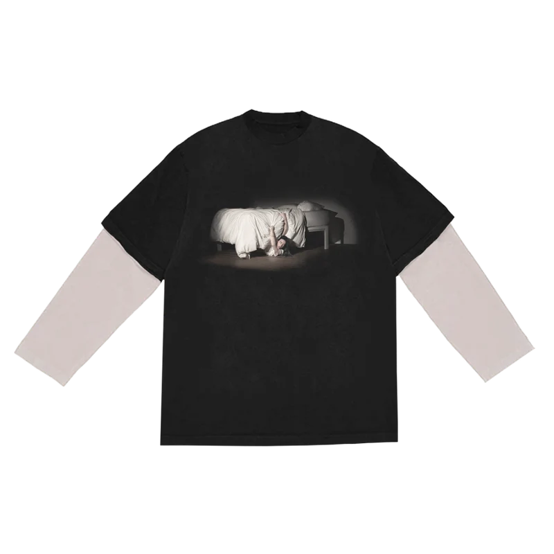 Front view of Billie Eilish's “WHEN WE ALL FALL ASLEEP, WHERE DO WE GO?” anniversary long sleeve tee in black, featuring a haunting photo of Billie crawling out from under a bed, with layered white sleeves. A standout piece from Billie Eilish’s official anniversary merch celebrating her debut album.

