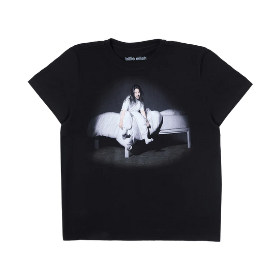 Black Billie Eilish anniversary t-shirt featuring the haunting WHEN WE ALL FALL ASLEEP, WHERE DO WE GO? album cover—Billie sitting on the edge of a white bed with glowing eyes and eerie expression. A fan-favorite graphic from her iconic debut era.

